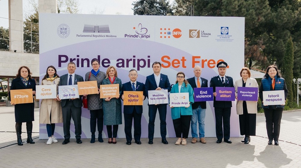 The participants are holding the campaign's support messages, in front of the banner