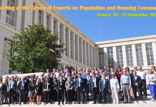 Participants of the conference posing in front of the building