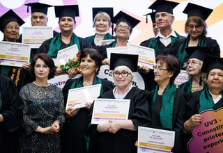 Senior older women holding diplomas at the graduation event