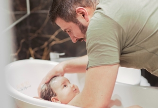 Gabriel bathing his son