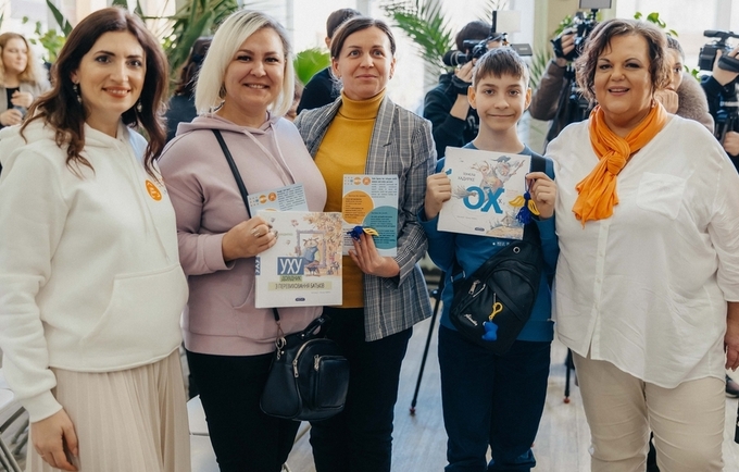 Ukrainian women and youth refugees standing with the coordinator at UNFPA Safe Space