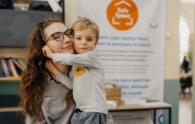 Anastasia is posing with her son at the UNFPA Safe Space