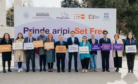 The participants are holding the campaign's support messages, in front of the banner