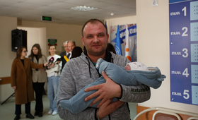 Tatăl ține în brațe copilul nou-născut 