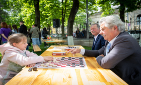 A grandfather and his niece playing checkers on Family Day