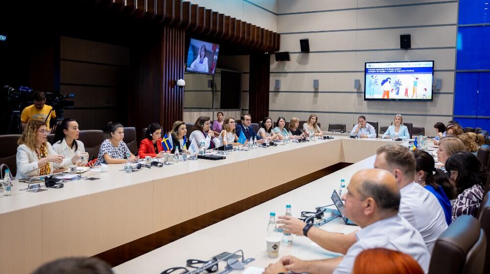 Participants at the launch of the study discussing at a round table, at the Parliament of the Republic of Moldova