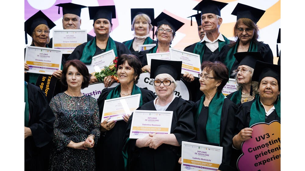 Senior older women holding diplomas at the graduation event