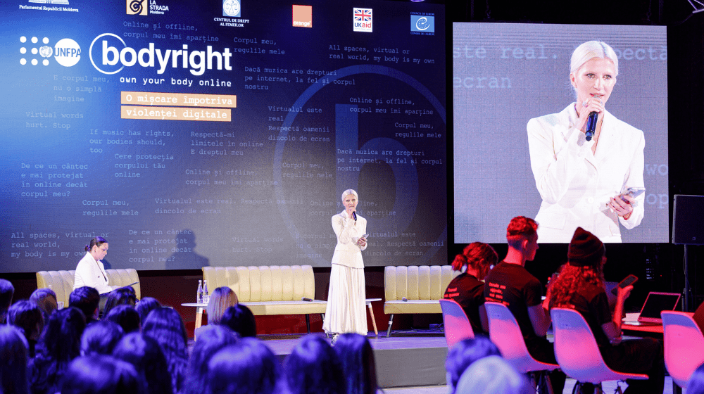 Singer Dara, ambasador of the bodyright campaign in Moldova, on stage, holding a speech