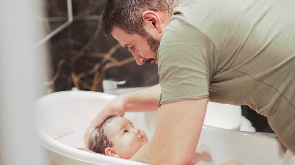 Gabriel bathing his son