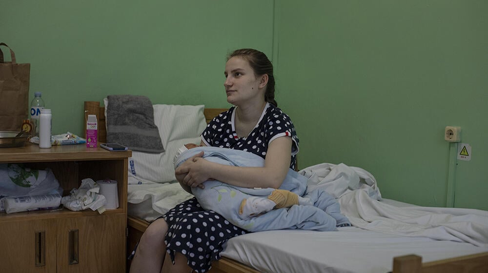 A woman is holding her newborn at the hospital in Balti