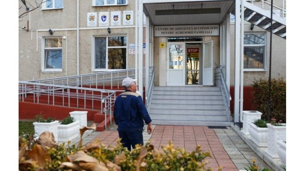 A man standing in front of the Aggressors' Centre in Drochia